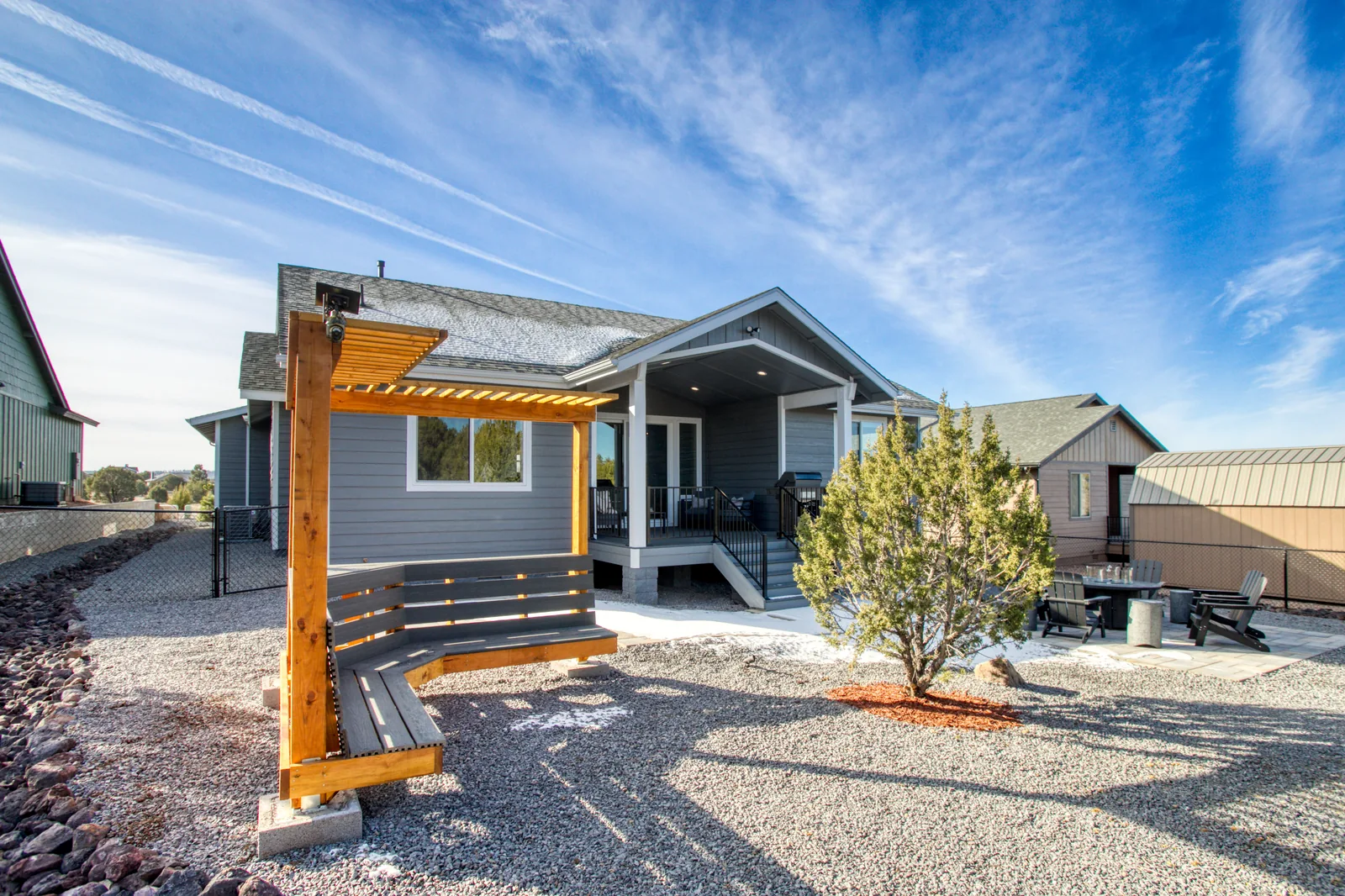 Backyard with pergola swing, fire pit patio, and covered deck