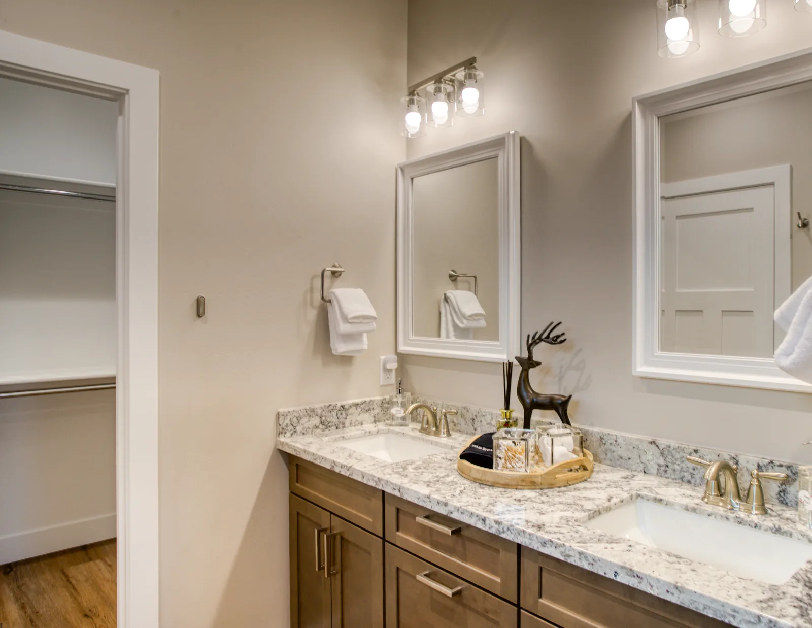Primary bathroom with double vanity and granite counters