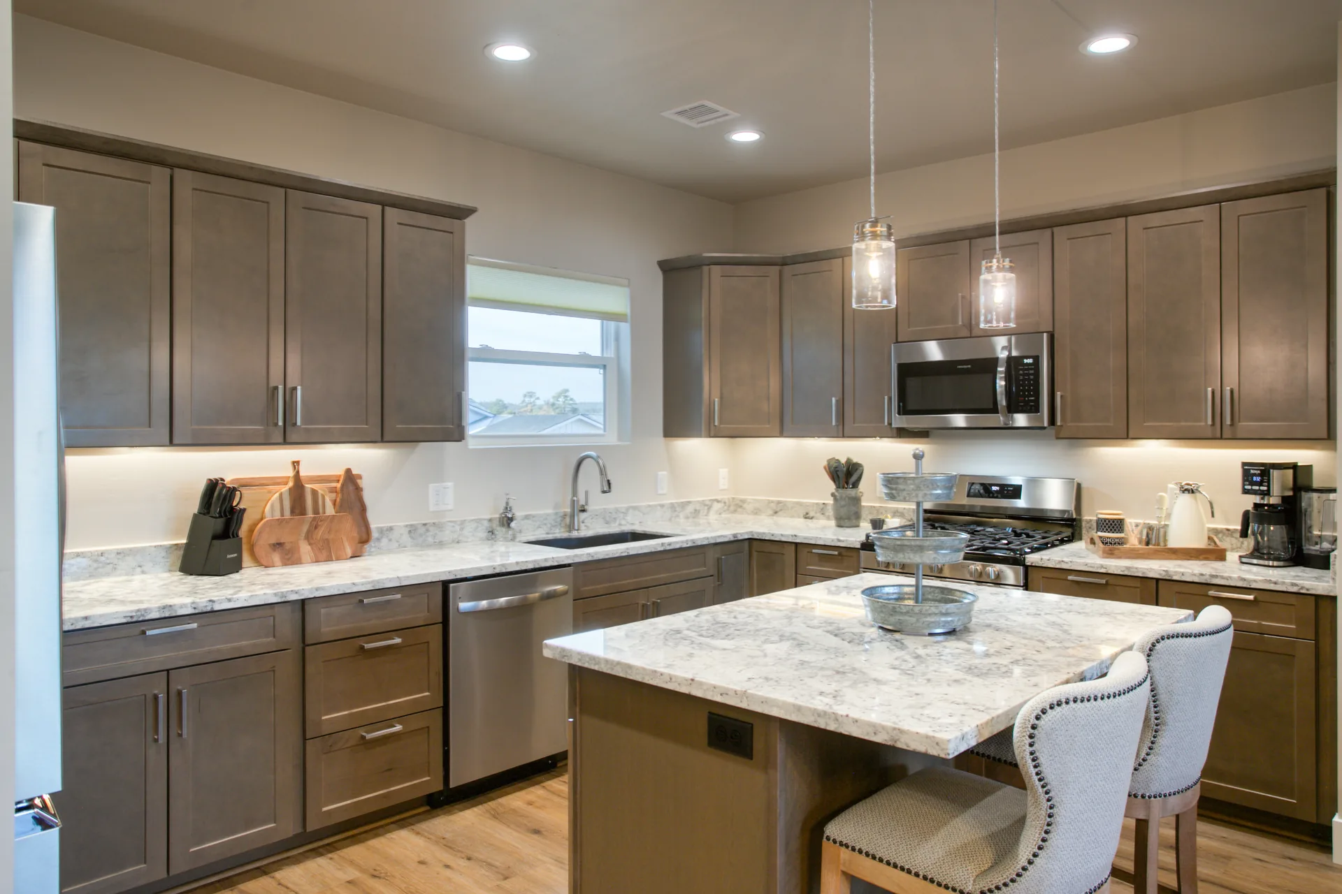 Fully equipped kitchen with island seating, stainless appliances, and coffee bar at Bluff Retreat