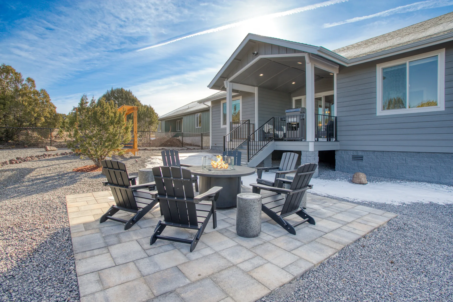 Back patio with fire pit and Adirondack chairs behind Bluff Retreat
